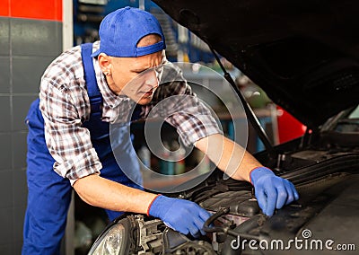 Mechanic technician working at service station Stock Photo