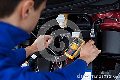 Mechanic testing car battery Stock Photo