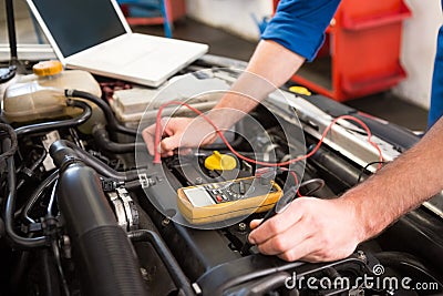 Mechanic using diagnostic tool on engine Stock Photo