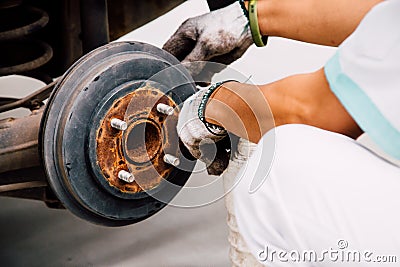 A mechanic worker replacing brake fluid. Stock Photo
