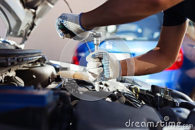 Mechanic working in auto repair garage. Car maintenance Stock Photo