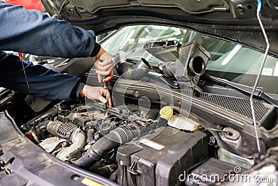 Mechanic working on a car engine doing repairs Stock Photo