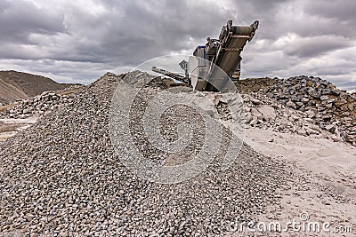 Mechanical conveyor belt to pulverize rock and stone and generate grave Stock Photo