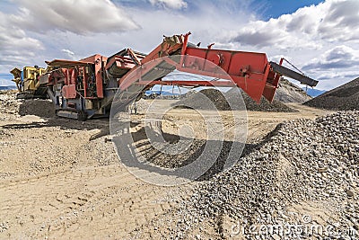 Mechanical conveyor belt to pulverize rock and stone and generate gravel Stock Photo