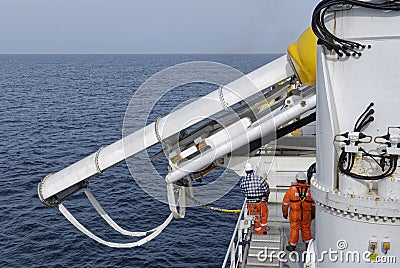 The Mechanical Department on a Seismic Vessel starting to deploy the in water equipment by firstly launching the F22 Barovane. Editorial Stock Photo