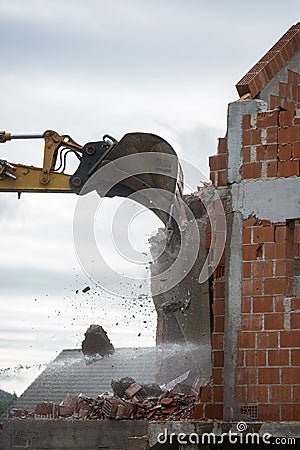Mechanical digger demolishing a building Stock Photo