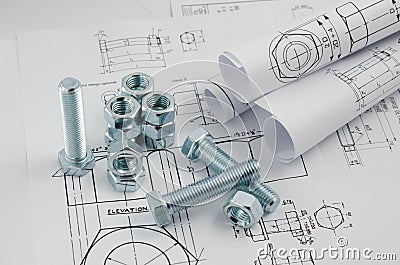 Mechanical Engineering Technology. Nuts and bolts on paper drawings Stock Photo