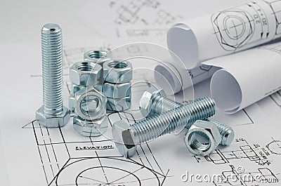 Mechanical Engineering Technology. Nuts and bolts on paper drawings Stock Photo