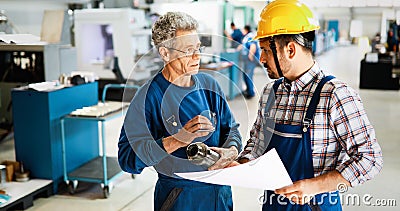 Supplier with engineer checking on production in factory Stock Photo