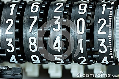 mechanical scoreboard with different white numbers on black counter rolls Stock Photo