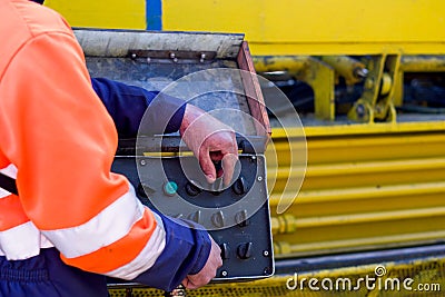 Mechanical technician operating on a control panel Stock Photo