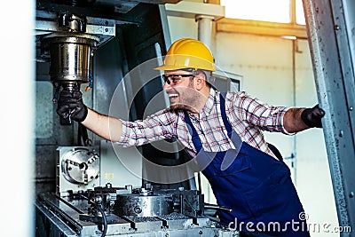 Mechanical technician worker of cnc milling cutting machine center at tool workshop manufacturing Stock Photo