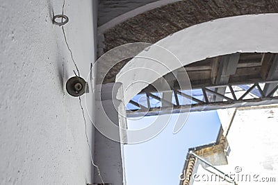 Mechanically operated doorbell on a torsion spring actuated by a wire Stock Photo