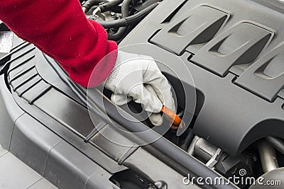 Mechanician performing maintenance on a car engine Stock Photo