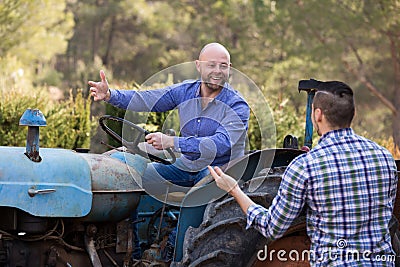 Mechanics reparing old agrimotors at farm Stock Photo
