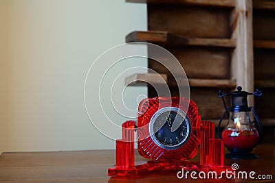 Antique table clock in a red frame on the table. Stock Photo