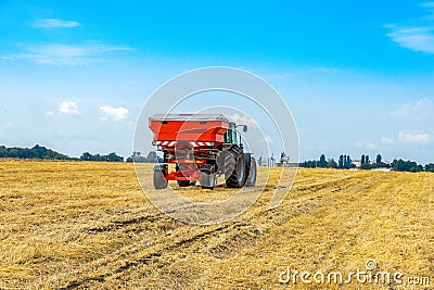 Mechanized fertilization with a tractor on the field Stock Photo
