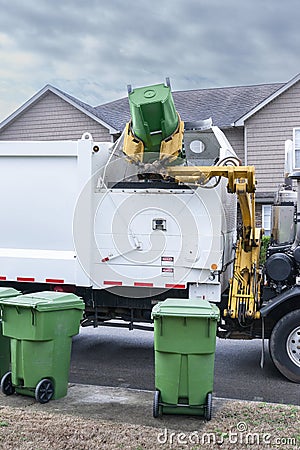 Mechanized Garbage Truck Dumping Trash From Residential Barrel Stock Photo