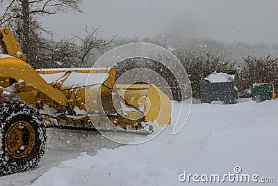 Mechanized tractor for snow removal is parked on a city street after snowfall Stock Photo