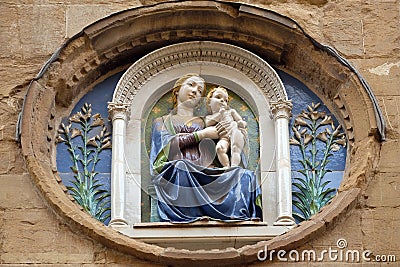Medallion with the Virgin Mary and Child by Luca della Robbia on the facade of Orsanmichele Church in Florence, Italy Stock Photo