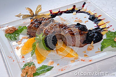 Medallions from pork with oranges Stock Photo