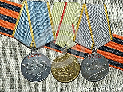 Medals `For the Defense of Stalingrad`, `For military merit ` on the background of the St. George`s ribbon.Awards of the soldier. Stock Photo