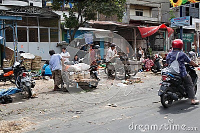 MEDAN, INDONESIA - AUGUST 18,2012: People transported goods in m Editorial Stock Photo