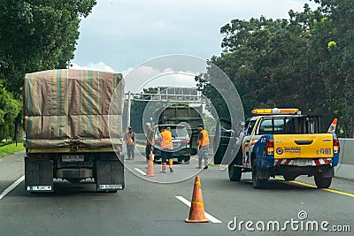 Construction roadworks at the highway. Freeway maintenance workers. Editorial Stock Photo