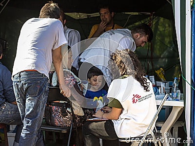 Medecins Sans Frontieres doctors discussing with a refugees family crossing border with Croatia. MSF is an NGO providing doctors Editorial Stock Photo