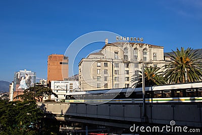 MEDELLIN, COLOMBIA - JANUARY 17, 2024: View of three icons of Medellin, Nutibara building, Metro and a reproduction of a painting Editorial Stock Photo