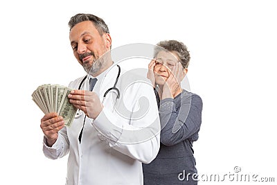 Medic counting money with patient looking Stock Photo