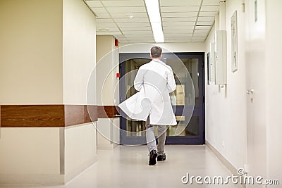 Medic or doctor walking along hospital corridor Stock Photo