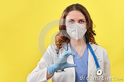 The medic shows the heart sign with his fingers, close-up. Doctor hand in medical glove with the sign of love for patients, Stock Photo