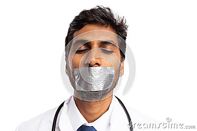 Medic silenced with mouth being taped Stock Photo