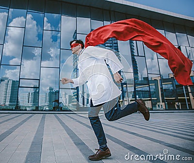 medic superhero hurries to the sick city resident. Stock Photo