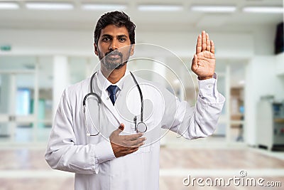 Medic swearing with hand on heart Stock Photo