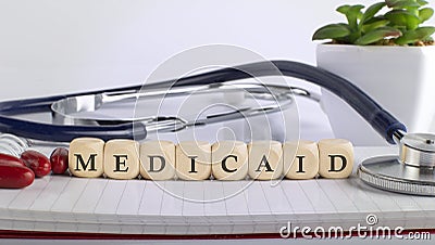 MEDICAID word made with building blocks, medical concept background Editorial Stock Photo