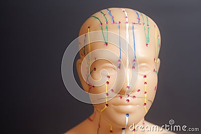 Medical acupuncture model of human head on black Stock Photo