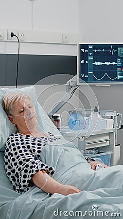 Medical assistant visiting retired patient sleeping Stock Photo