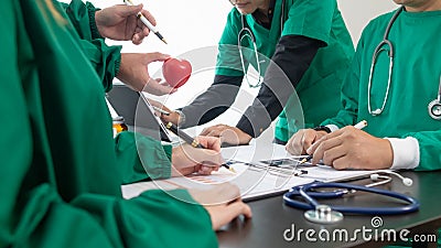 The medical attended a meeting with a team of cardiologists to discuss surgery plans for a heart patient after the medical team Stock Photo