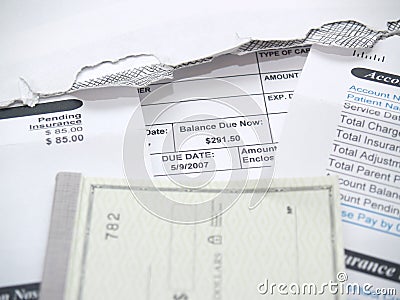 A medical bill and check book Stock Photo