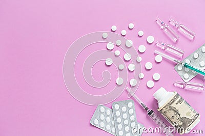 Medical bootle with dollars, packaging with pills, ampullas and expendable syringes for vaccination. The concept of insurance Stock Photo