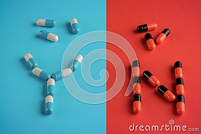 Medical capsules of two kinds. The concept of choice, awareness, side effect Stock Photo