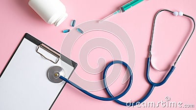 Medical checkup concept. Medical equipment on pink background. Top view doctors table with stethoscope, medical clipboard, syringe Stock Photo