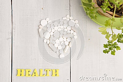 Medical concept - HEALTH inscription and white heart of pills a Stock Photo