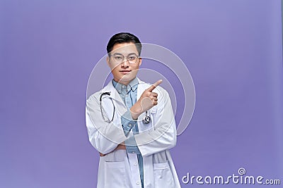 Medical concept of professional male doctor pointing with hand on copy space Stock Photo