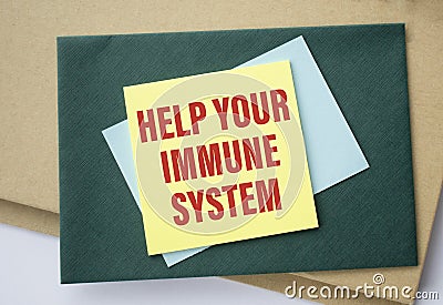 Yellow paper with word HELP YOUR IMMUNE SYSTEM on white desk Stock Photo