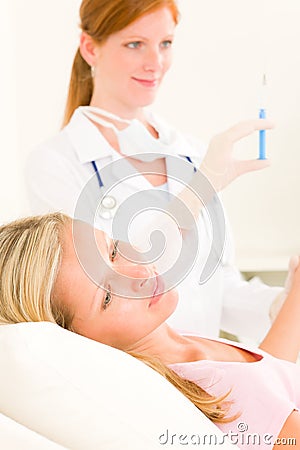 Medical doctor apply injection to woman patient Stock Photo