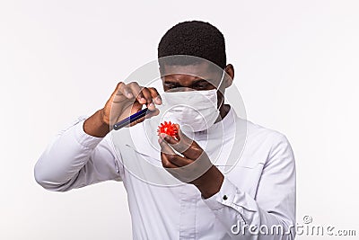 Medical doctor or laborant holding tube with Coronavirus vaccine for COVID-19. Coronavirus model in human hand. Vaccine Stock Photo