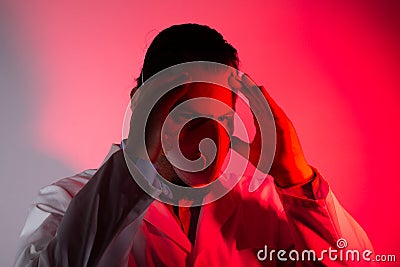 Medical doctor wearing a respiratory mask. Red light emergency and medicine crisis concept Stock Photo